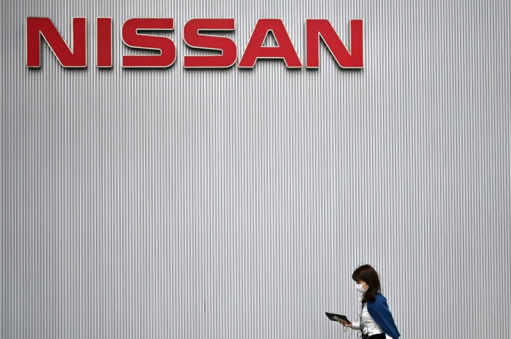 A woman walks near the Nissan Motor Corporation headquarters in Yokohama on May 28, 2020