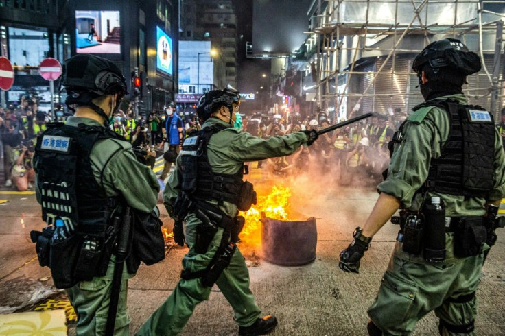 Police stand guard to deter pro-democracy protesters from blocking roads in the Mong Kok district of Hong Kong on May 27, 2020