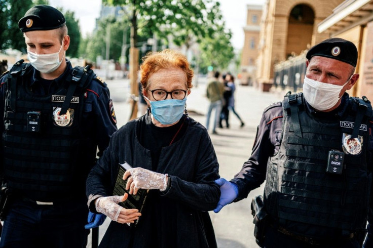 Police officers detained Russian photographer Victoria Ivleva in Moscow on Thursday during a solo picket in support of journalist and activist Ilya Azar