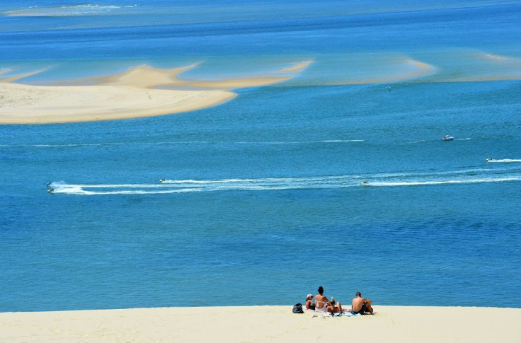 People enjoy a sunny day atop Europe's tallest sand dune, the "Dune du Pilat", after its reopening in La Teste-de-Buch, France