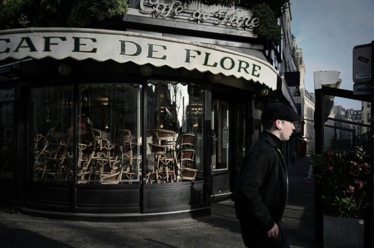 A man walks past the closed Cafe de Flore in Paris in March 2020 -- restaurants and cafes will be allowed to serve some customers on outside terraces from June 2, 2020