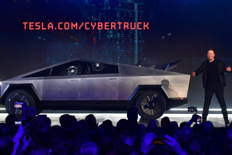 Tesla co-founder and CEO Elon Musk on stage with  the newly unveiled all-electric battery-powered Tesla Cybertruck with broken glass on windows following a demonstation that did not quite go as planned on November 21, 2019 in California