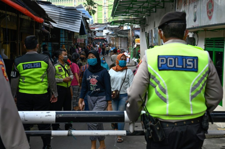 Alongside police and troops overseeing enforcement measures, provincial leaders are running their own zealous campaigns to fight the virus in Indonesia