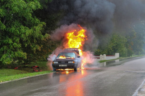 man drags driver away from burning car