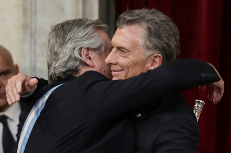 Outgoing president Mauricio Macri embraces his leftist rival and new Argentine President Alberto Fernandez at the inauguration in Buenos Aires on December 10, 2019
