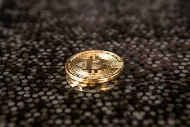 Gold-colored Bitcoin coin on ground
