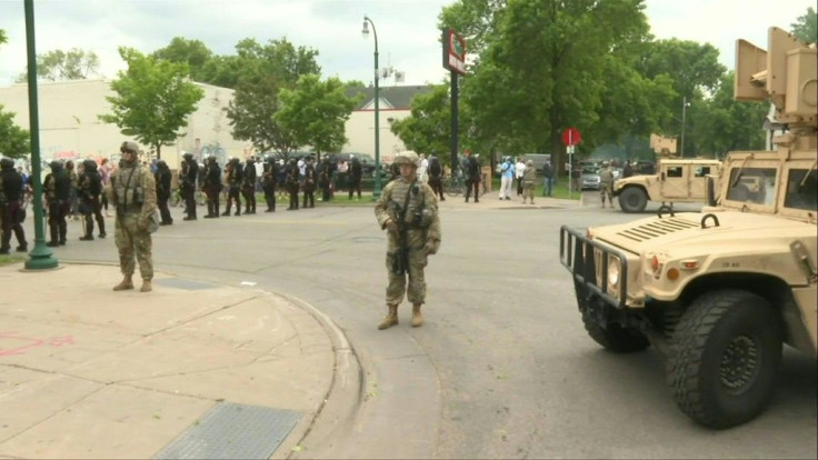 IMAGES National Guard soldiers are deployed in Minneapolis for peacekeeping after a third night of rioting over police brutality against African Americans left hundreds of shops damaged and a police station on fire.