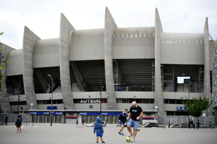 Children play football outside PSG's Parc des Princes home during the lockdown in France in April