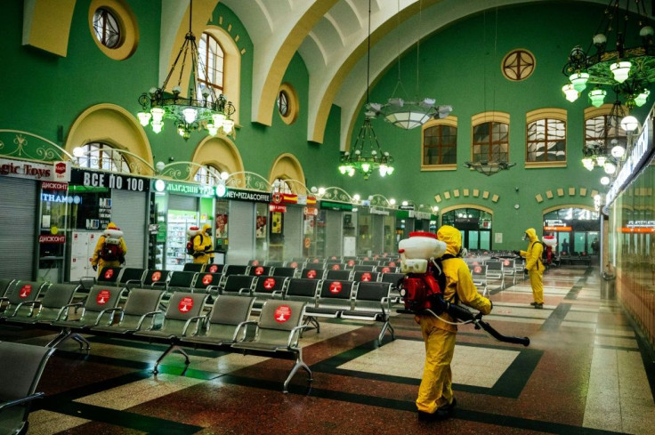 Workers for Russia's emergencies ministry disinfect Kazansky railway station in Moscow, the epicenter of the country's coronavirus outbreak