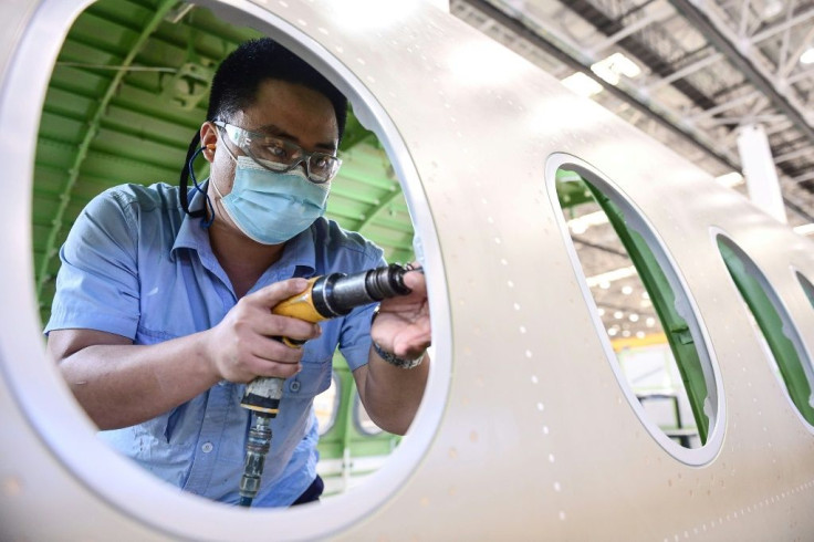 An employee works on an Airbus A220 aircraft at a factory in Shenyang in China's northeast