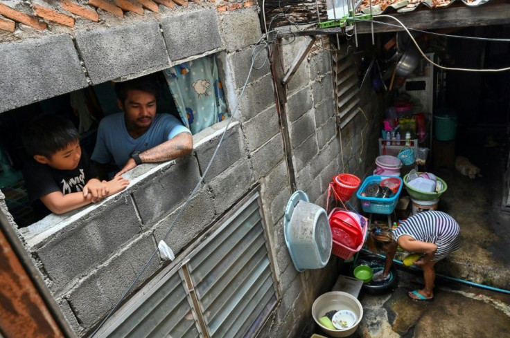 The economic devastation unleashed by the coronavirus has put intense pressure on Thailand's poor, like motorcycle rickshaw driver Thanapat Noidee (R)