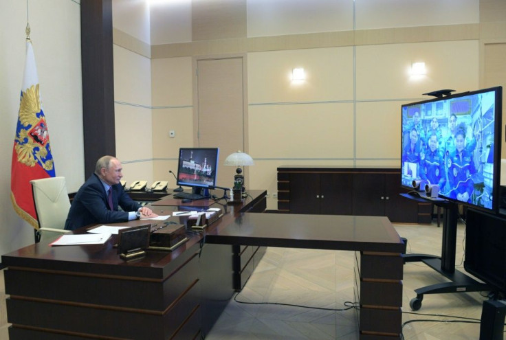 Russian President Vladimir Putin holds a video link with cosmonauts onboard the International Space Station