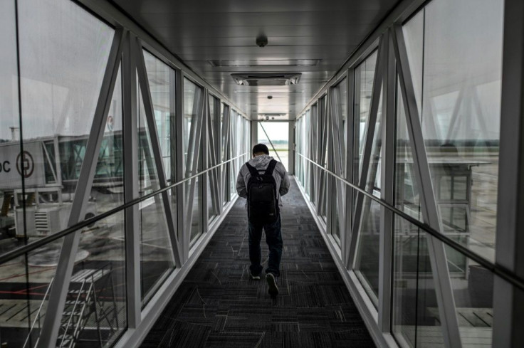A passenger walks along an airbridge at Tianhe Airport in Wuhan