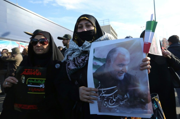 A Iranian woman carries a portrait of slain Iranian General Qasem Soleimani, on the 40th day of his killing in a US drone strike, during commemorations marking 41 years since the Islamic Revolution, on February 11