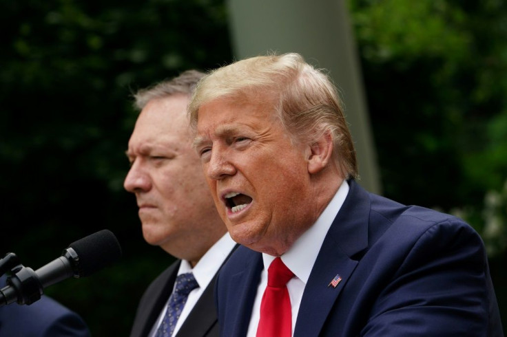 US President Donald Trump, pictured here with Secretary of State Mike Pompeo, in 2018 withdrew the US from a landmark nuclear accord and began reimposing crippling sanctions on Iran's economy