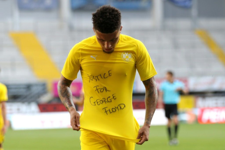 Dortmund's England winger Jadon Sancho shows a T-Shirt bearing the message "Justice for George Floyd" after scoring against Paderborn on Sunday.
