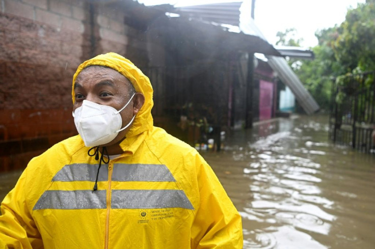 An employee of the Public Works Ministry is seen in the flooded Santa Lucia colony in Ilopango, El Salvador, during Tropical Storm Amanda