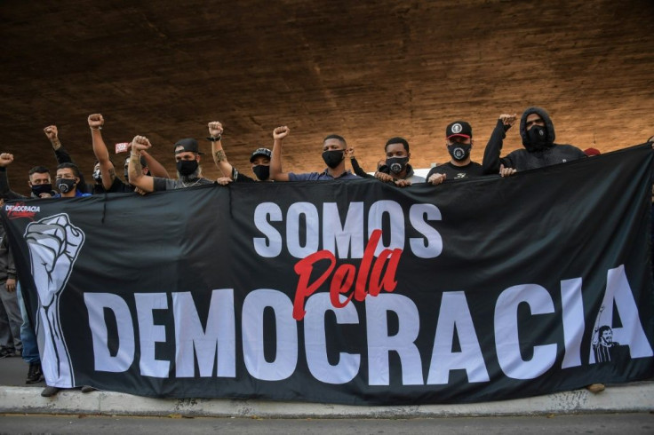 Brazilian opponents to President Jair Bolsonaro organized by football fan clubs marched Sao Paulo and clashed with pro-government activists