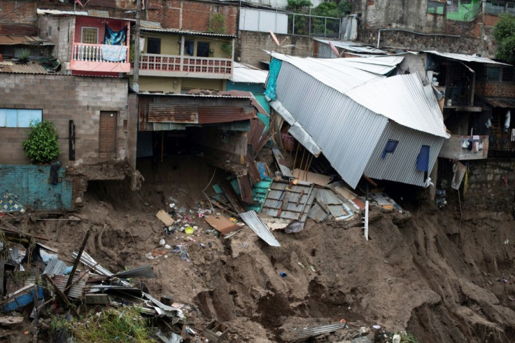 Landslides and swollen rivers destroyed homes in working-class neighborhoods of El Salvador's capital San Salvador