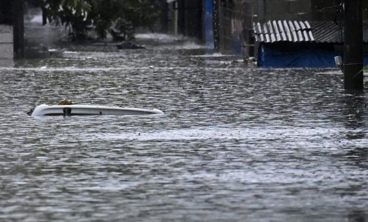 Flooding was especially intense in the Santa Lucia neighborhood of Ilopango, El Salvador, where the roof of a vehicle is barely visible in the flood water