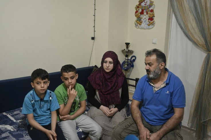 Abdelkader Rahmoun (R), a 44-year-old Syrian, and his familyare among thousands of recognised refugees about to lose their temporary homes