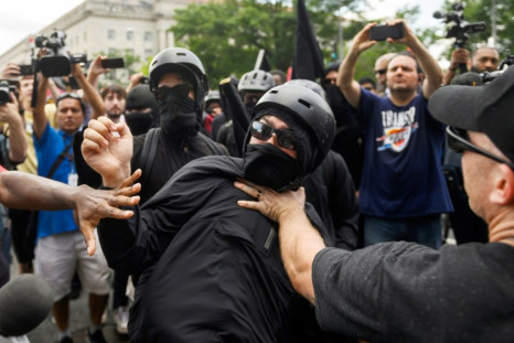 A member of the Antifa group is held back while he argues with a Trump supporter during a rally of right-wing groups in Washington on July 6, 2019.