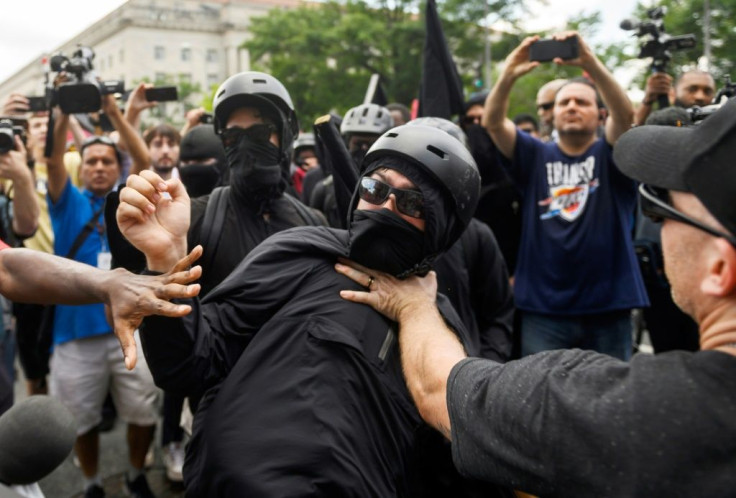 A member of the Antifa group is held back while he argues with a Trump supporter during a rally of right-wing groups in Washington on July 6, 2019.