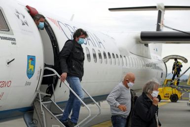 Passengers wearing masks get off a plane at Zagreb International Airport Croatia, on May 11, 2020