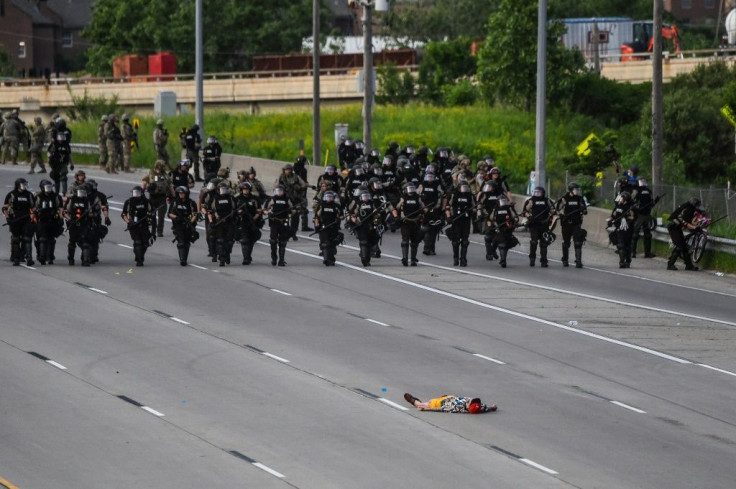 A demonstrator lies on the highway in front of the police line during a protest over the death of George Floyd on May 31, 2020 in Minneapolis