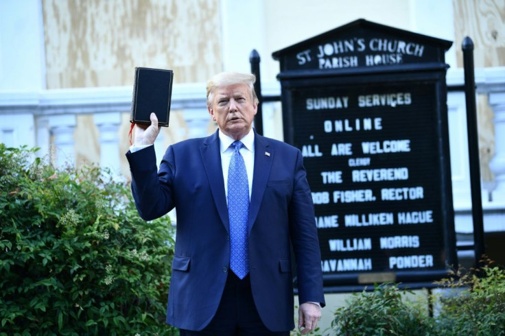 US President Donald Trump holds up a bible in front of St John's Episcopal church after walking across Lafayette Park from the White House in Washington, DC on June 1, 2020