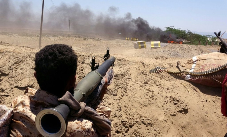 A southern separatist fighter watches as a military vehicle belonging to Yemen's Saudi-backed government forces burns during clashes in Abyan province on May 11