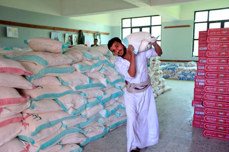 A man carries a sack of food aid in Yemen's capital Sanaa