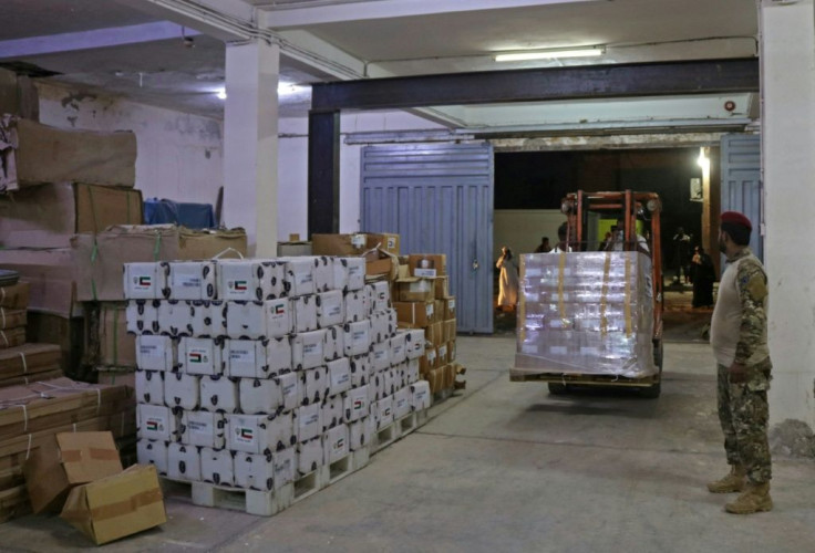 Yemeni men unload medical aid at a hospital warehouse in the war-torn country's second city of Aden, in early May
