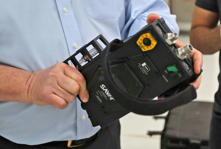 James W. Teetzel, CEO and founder of American defence manufacturer Wilcox, holds a medical ventilator at Qatar's Barzan facility, in the capital Doha