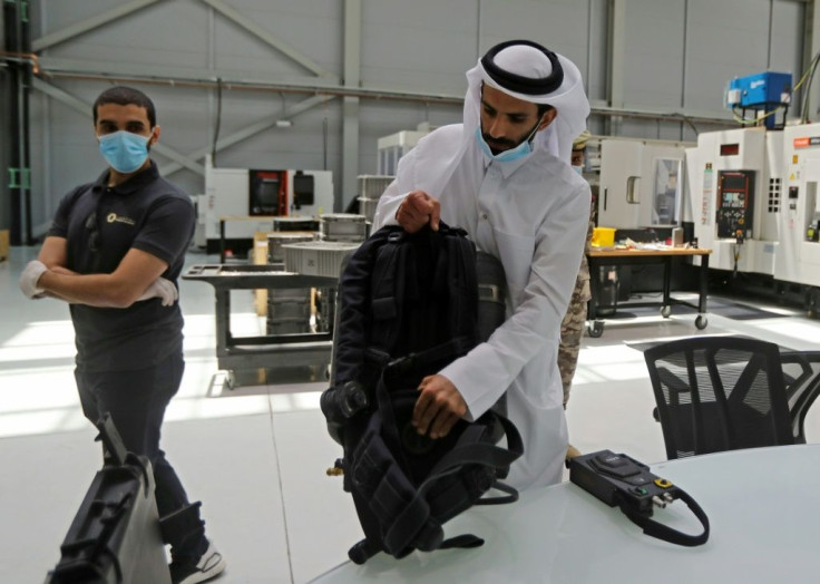 Ahmed Rashed Al-Moosafri (R), the director of Qatar's Barzan facility, shows an amphibious assault respirator device which contains the component now being used in a medical ventilator