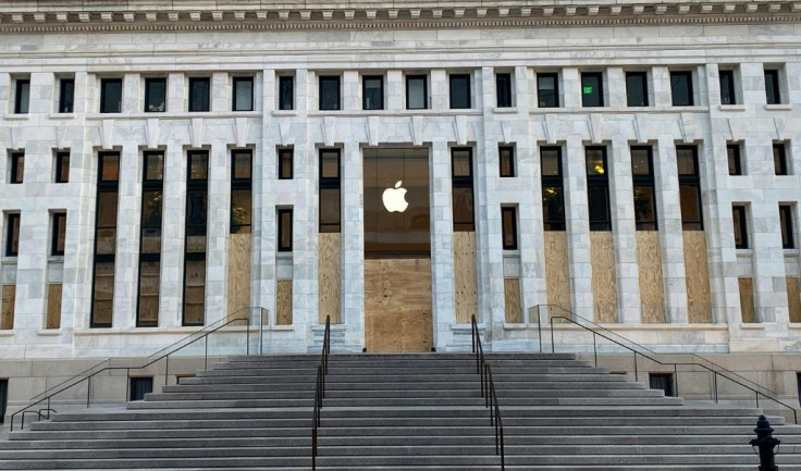 The windows of the Apple store in Washington DC on June 1, 2020 are boarded up after being looted in the night following protests