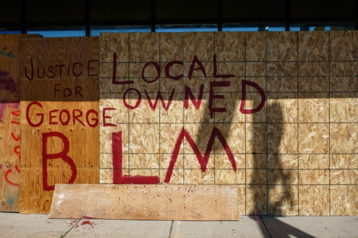 Business owners have boarded up their shops with panels that read "Justice for George," "Kids live here" or "Minority Owned," in an attempt to deter protesters