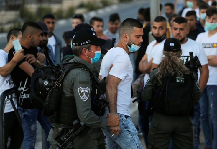 Israeli security forces detains a Palestinian protester during a demonstration at the Damascus Gate of the old city of Jerusalem condemning the shooting of Iyad Hallak