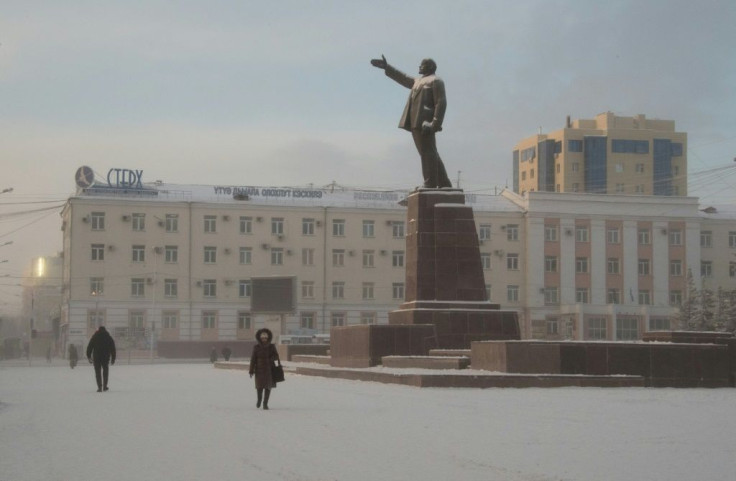 Locals walk through a square in the Siberian city of Yakutsk, where a court ruled to commit a shaman critical of Vladimir Putin to a mental asylum