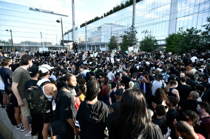 Protesters gather in Paris for a demonstration after French medical experts exonerated the gendarmes involved in the arrest of Adama Traore, a young black man who died in police custody in 2016.