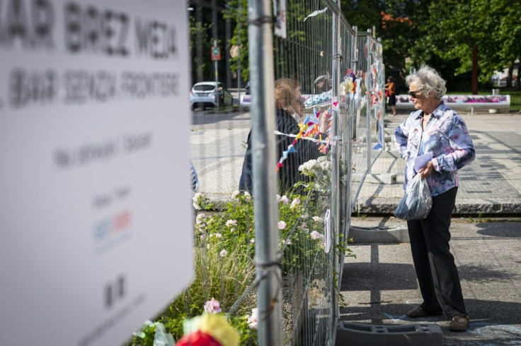 People in in Nova Gorica/Gorizia chat across the border fence between Slovenia and Italy, erected due to the Covid19 pandemic