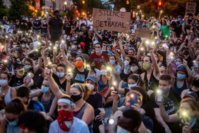 Protesters hold up their phones during a demonstration over the death of George Floyd, outside the White House in Washington, DC