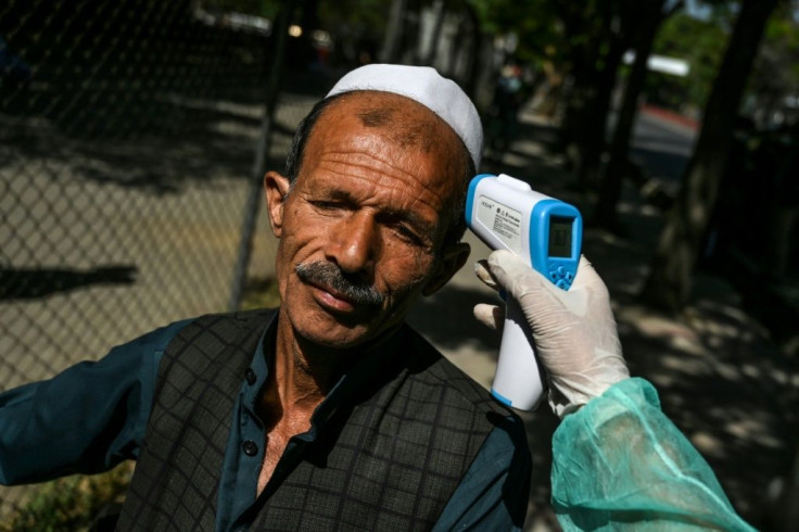 A man has his temperature checked by a health worker at the Wazir Akbar Khan mosque in Kabul