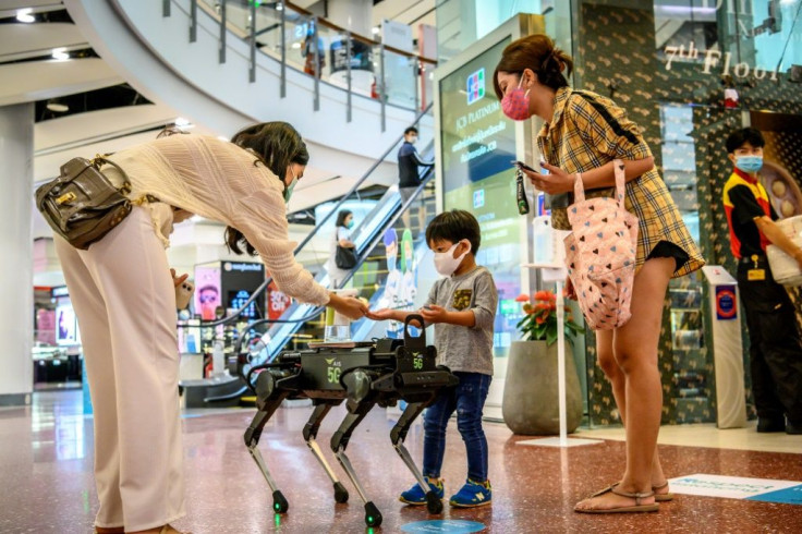A 5G K9 robot distributes hand sanitiser to visitors in a shopping mall in Bangkok
