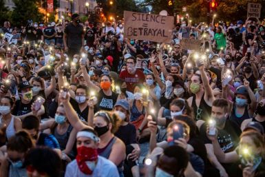 Protesters hold up their phones during a demonstration over the death of George Floyd, outside the White House in Washington, DC