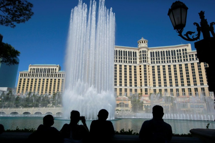 The Bellagio's fountains were switched back on shortly before its sprawling casino floors reopened, as dozens of curious locals and excited tourists lined up to enter at 10 am