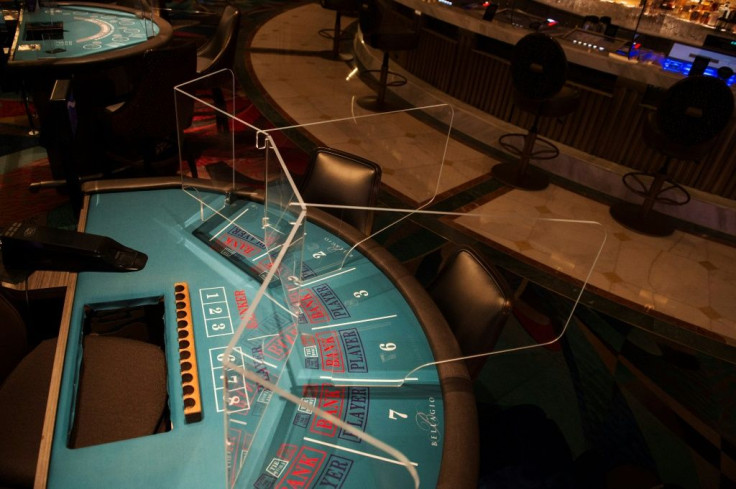Welcome to the new normal: a transparent partition separates players at a table game at the Bellagio Hotel and Casino in Las Vegas