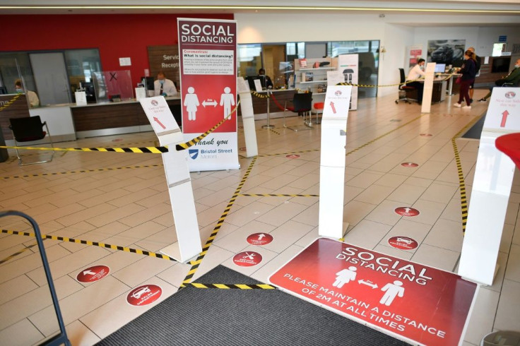 Social distancing markers are displayed inside the recently re-opened Vauxhall car dealership as post-lockdown business takes off