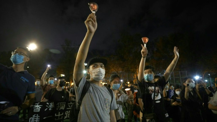 Thousands of Hong Kong protesters lit candles and chanted democracy slogans as they defied a ban Thursday against gathering to commemorate China's deadly Tiananmen crackdown, with tensions seething in the financial hub over a planned new security law.