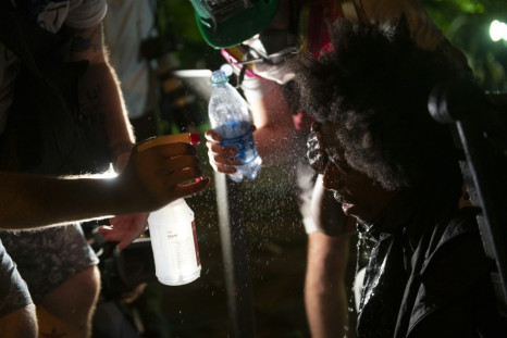 Protestors wash their eyes with water after being sprayed by tear gas in Washington, May 31, 2020